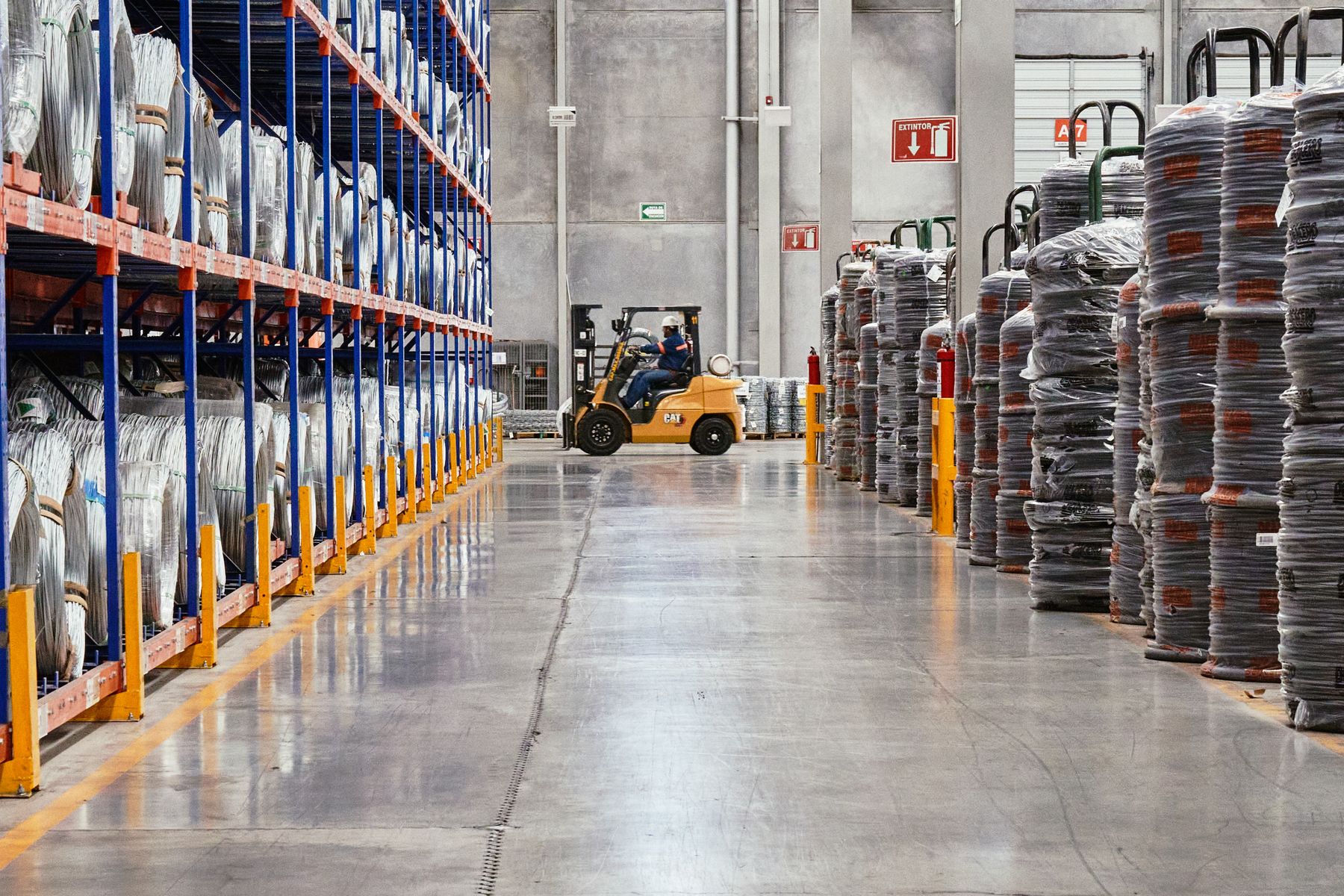 Organized industrial materials and equipment moving through a warehouse